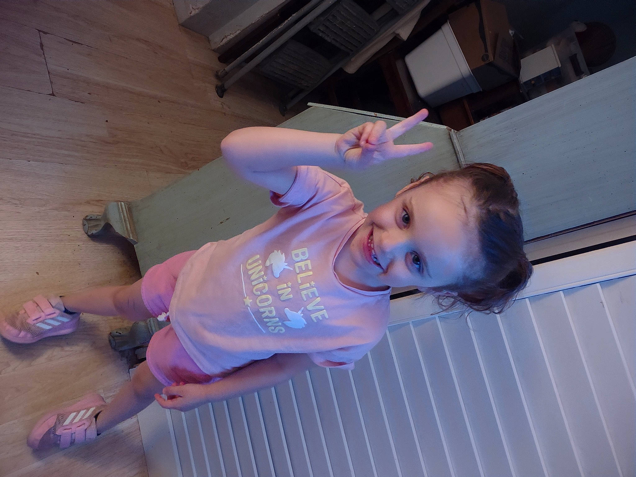 Ruby is registered to the contest to win money with this photo: baby_toddler_clothing, child, elbow, electric_blue, flooring, fun, hat, human_leg, joy, knee, leisure, person, purple, sandal, smile, t_shirt, thigh, toddler, walking_shoe, wood