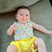 Elizabeth joined the competition — help win amazing prizes! arm, baby, child, clothing, comfortable, couch, cute, face, floral_top, happy, indoors, infant, leg, portrait, sitting, skin, smile, textured_fabric, toddler, yellow_shorts