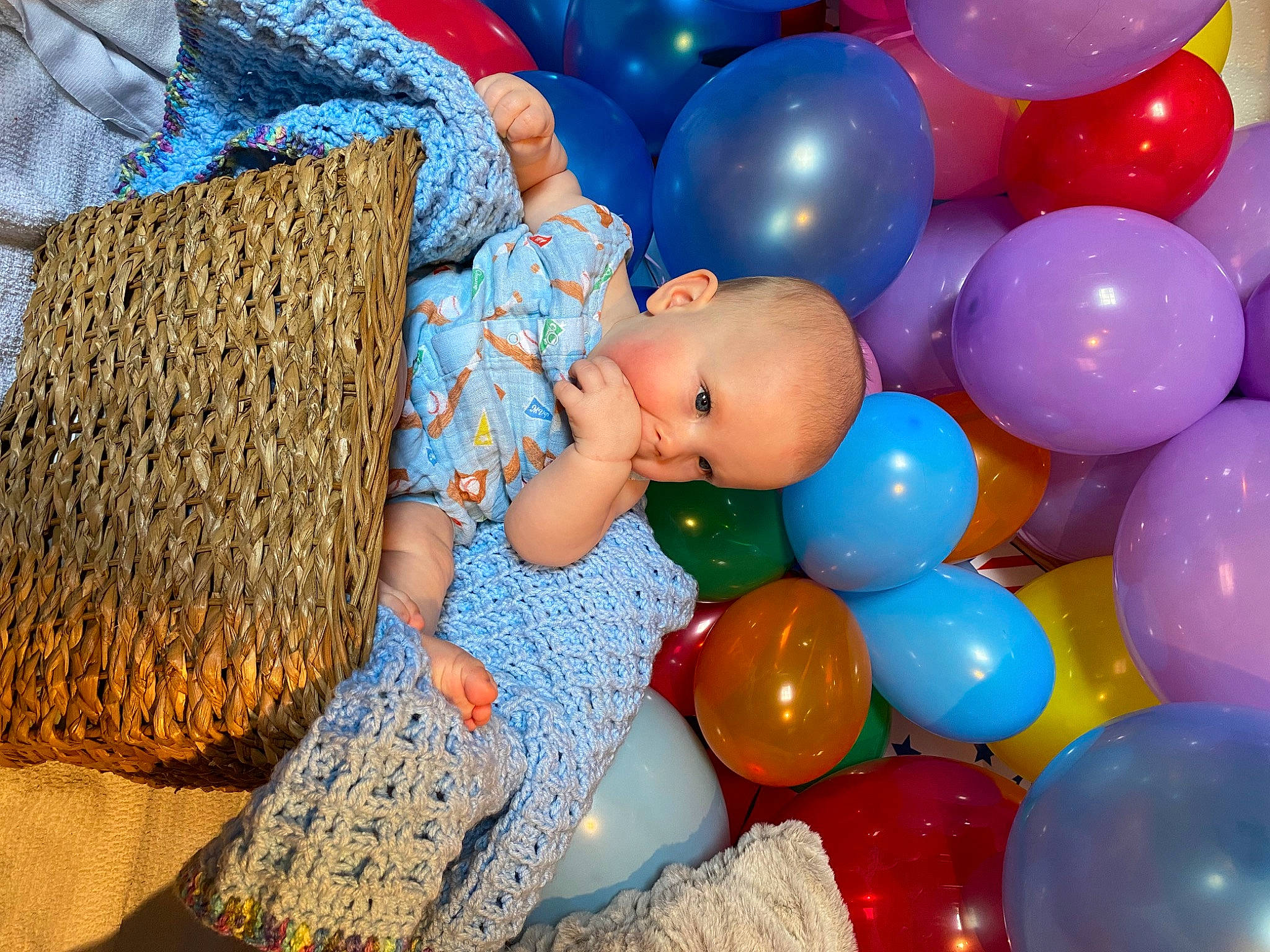Wyatt is registered to the contest to win money with this photo: baby, baby_toddler_clothing, balloon, blue, child, event, fun, happy, inflatable, leisure, mammal, party_supply, pattern, person, plastic, play, recreation, sitting, toddler, toy