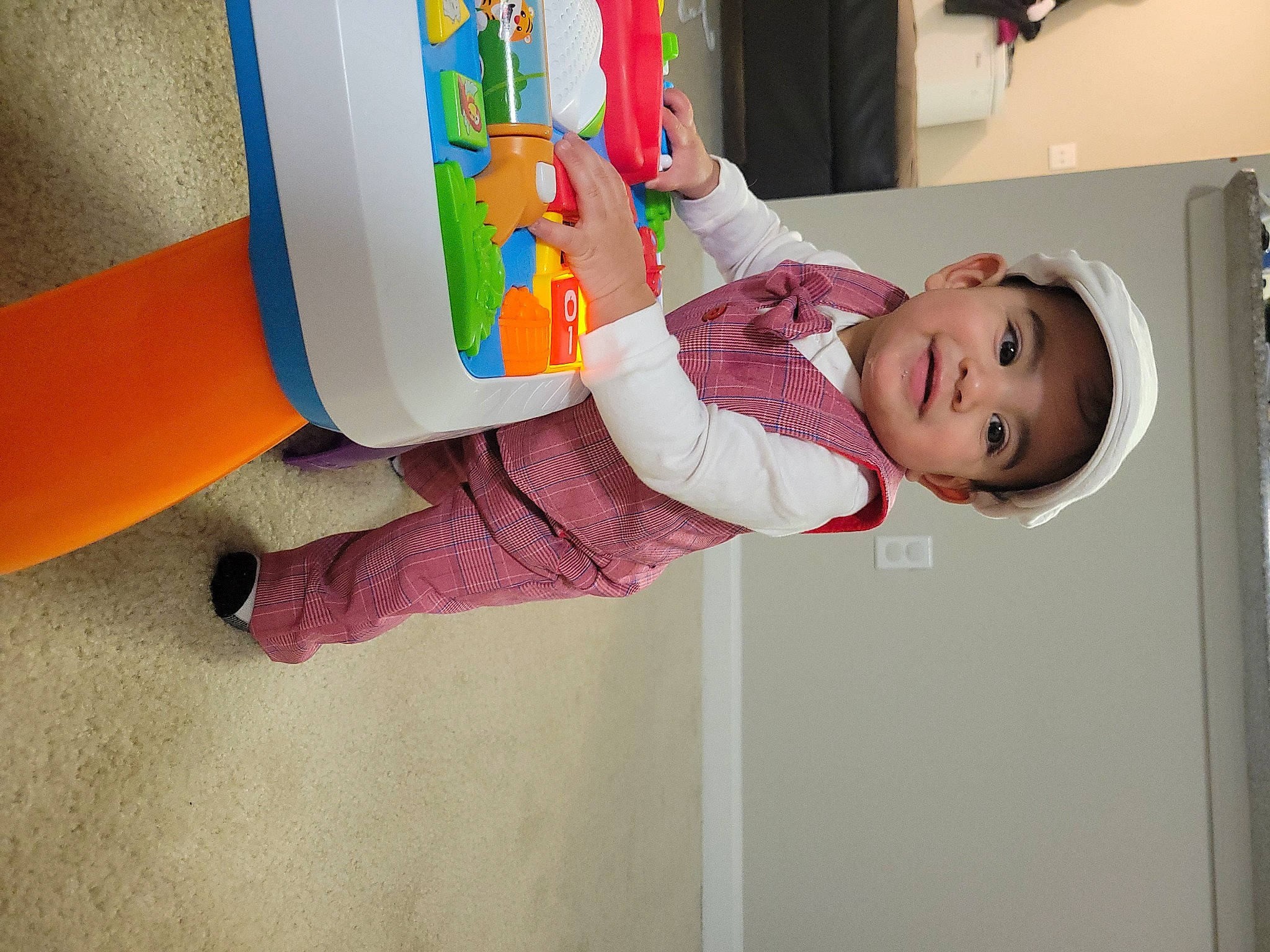 Lucifer is registered to the contest to win money with this photo: art, baby, baby_products, baby_toddler_clothing, child, fun, happy, joy, magenta, paint, pattern, person, play, room, sleeve, smile, sock, t_shirt, toddler