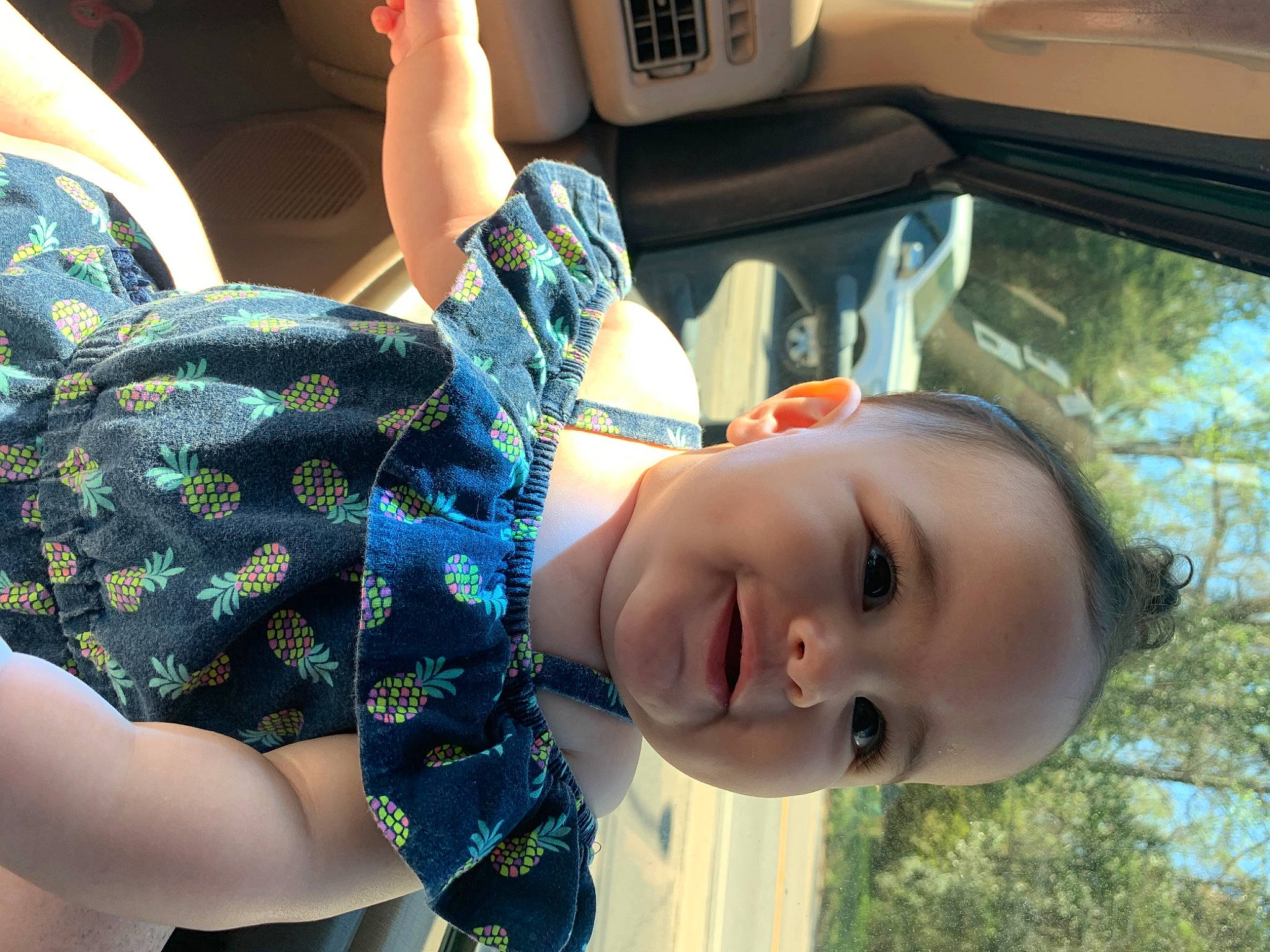 Bailee is registered to the contest to win money with this photo: black_hair, car_seat, child, cool, facial_expression, fun, grass, hairstyle, happy, leisure, light, mouth, nose, person, plant, smile, summer, toddler, tree, vehicle_door