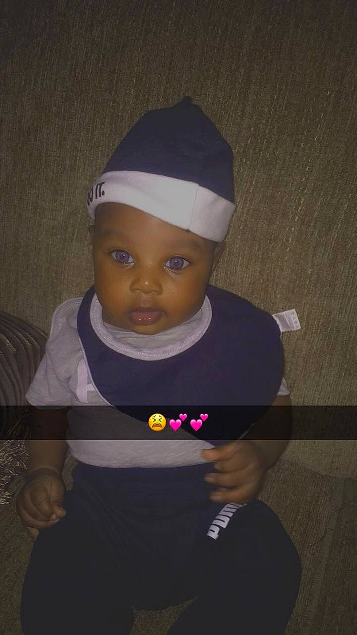 Chase is registered to the contest to win money with this photo: arm, baby, baby_toddler_clothing, baseball_cap, cap, cheek, child, eye, fashion_accessory, flash_photography, fun, happy, headgear, headwear, knit_cap, person, room, selfie, sitting, sleeve