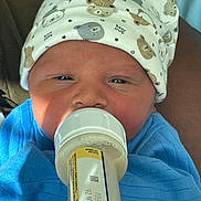 Savior joined the competition — help win amazing prizes! baby, bear_print, blue_clothing, bottle_label, cheeks, close_up, cozy, eyes, face, feeding, feeding_bottle, hat, indoor, infant, newborn, newborn_face, person, portrait, skin, swaddle