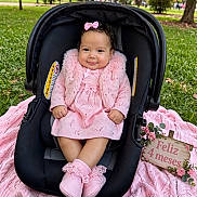 Susej is registered to the contest to win money with this photo: baby, blanket, booties, bow, car_seat, celebration, child, dress, flowers, four_months, grass, hair_bow, infant, outdoor, park, pink_outfit, portrait, smiling, stroller, trees