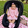 baby, blanket, booties, bow, car_seat, celebration, child, dress, flowers, four_months, grass, hair_bow, infant, outdoor, park, pink_outfit, portrait, smiling, stroller, trees