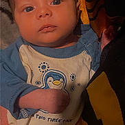 Atreus is registered to the contest to win money with this photo: baby, infant, face, person, clothing, blue, penguin, cute, newborn, hand, portrait, child, apparel, soft, skin, expression, indoors, holding, sleeve, young