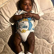 Andre Jr joined the competition — help win amazing prizes! baby, infant, onesie, socks, bed, blanket, cute, child, lying_down, skin, hands, legs, face, expression, clothing, soft, comfort, indoors, portrait, sleepwear