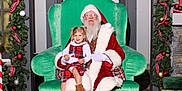 Aarika joined the competition — help win amazing prizes! child, girl, santa_claus, christmas, holiday, festive, plaid_dress, green_chair, decorations, garland, red_ribbons, ornaments, boots, indoor, portrait, smiling, happy, seasonal, celebration, event