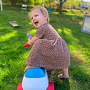 Adaline joined the competition — help win amazing prizes! toddler, child, toy_car, smiling, outdoor, grass, greenery, dress, happy, playtime, sunlight, backyard, fun, cute, person, baby, leisure, summer, nature, joyful