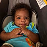 Anfonee is registered to the contest to win money with this photo: baby, infant, child, smile, curly_hair, blue_onesie, baby_seat, cushion, comfort, cute, hands, expression, indoor, closeup, portrait, playful, colorful_clothing, young, happy, small_person