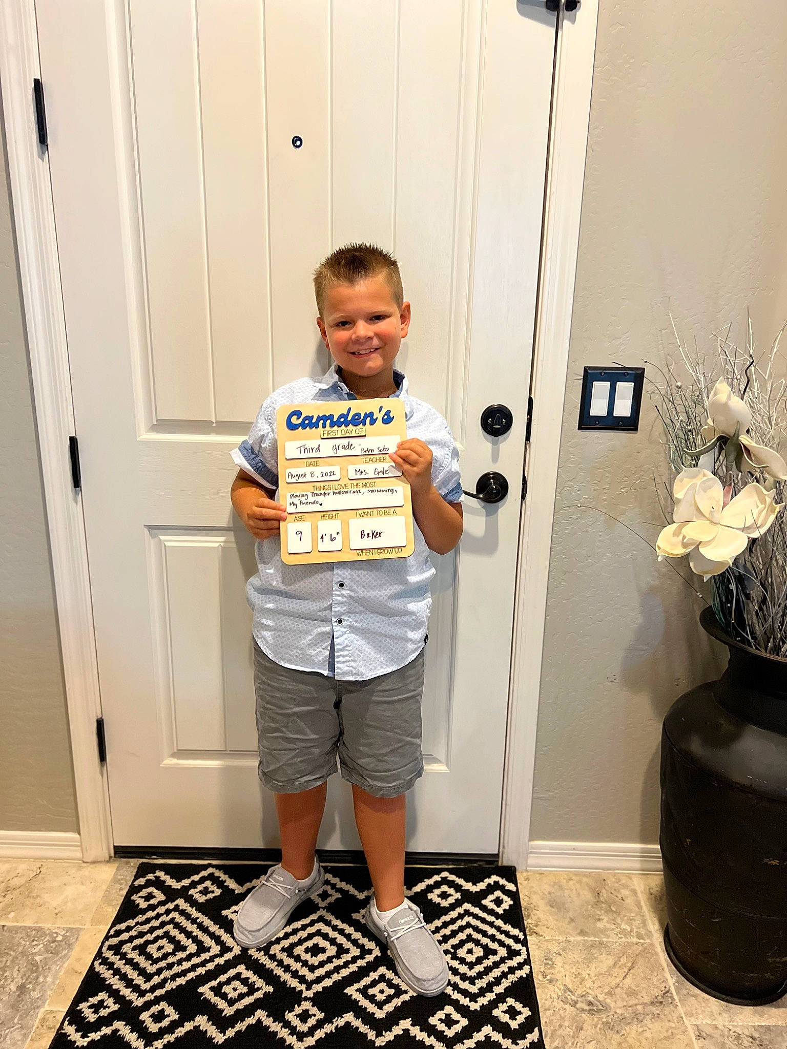 Camden joined the competition — help win amazing prizes! bermuda_shorts, black, board_short, door, electric_blue, flooring, flowerpot, home_door, houseplant, human_leg, joy, pattern, person, room, shorts, sleeve, smile, standing, t_shirt, top