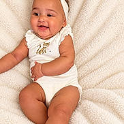 Lianna joined the competition — help win amazing prizes! baby, infant, child, smiling, happy, portrait, lying_down, blanket, soft_blanket, headband, bow, onesie, leopard_print, indoor, close_up, face, arms, legs, cute, photography