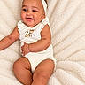 baby, infant, child, smiling, happy, portrait, lying_down, blanket, soft_blanket, headband, bow, onesie, leopard_print, indoor, close_up, face, arms, legs, cute, photography