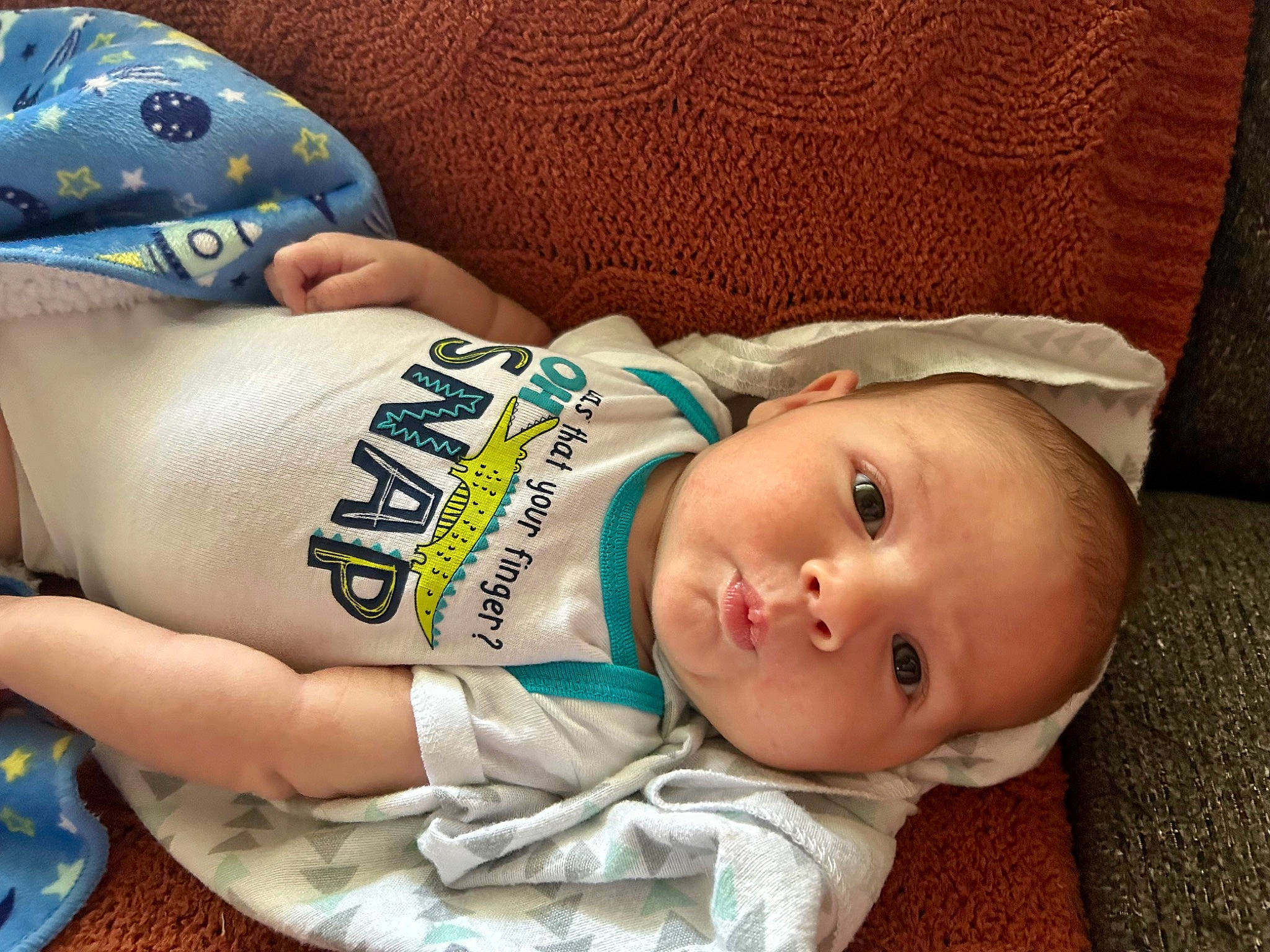 Cameron joined the competition — help win amazing prizes! baby, baby_toddler_clothing, baseball_cap, cheek, child, comfort, elbow, eyelash, happy, headgear, human_leg, pattern, person, personal_protective_equipment, sitting, skin, sleeve, thigh, toddler, wood