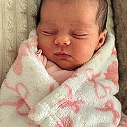 Gabriella is registered to the contest to win money with this photo: newborn, baby, sleeping, blanket, pink, white, soft, cute, infant, wrapped, cozy, face, head, peaceful, closeup, child, portrait, resting, indoors, warm