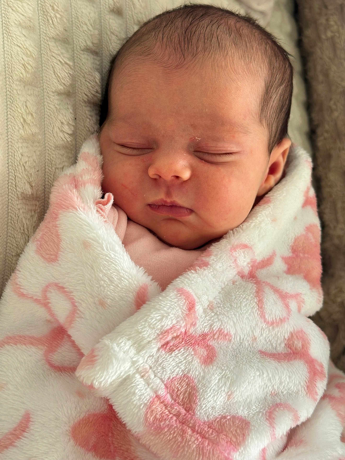 Gabriella is registered to the contest to win money with this photo: newborn, baby, sleeping, blanket, pink, white, soft, cute, infant, wrapped, cozy, face, head, peaceful, closeup, child, portrait, resting, indoors, warm
