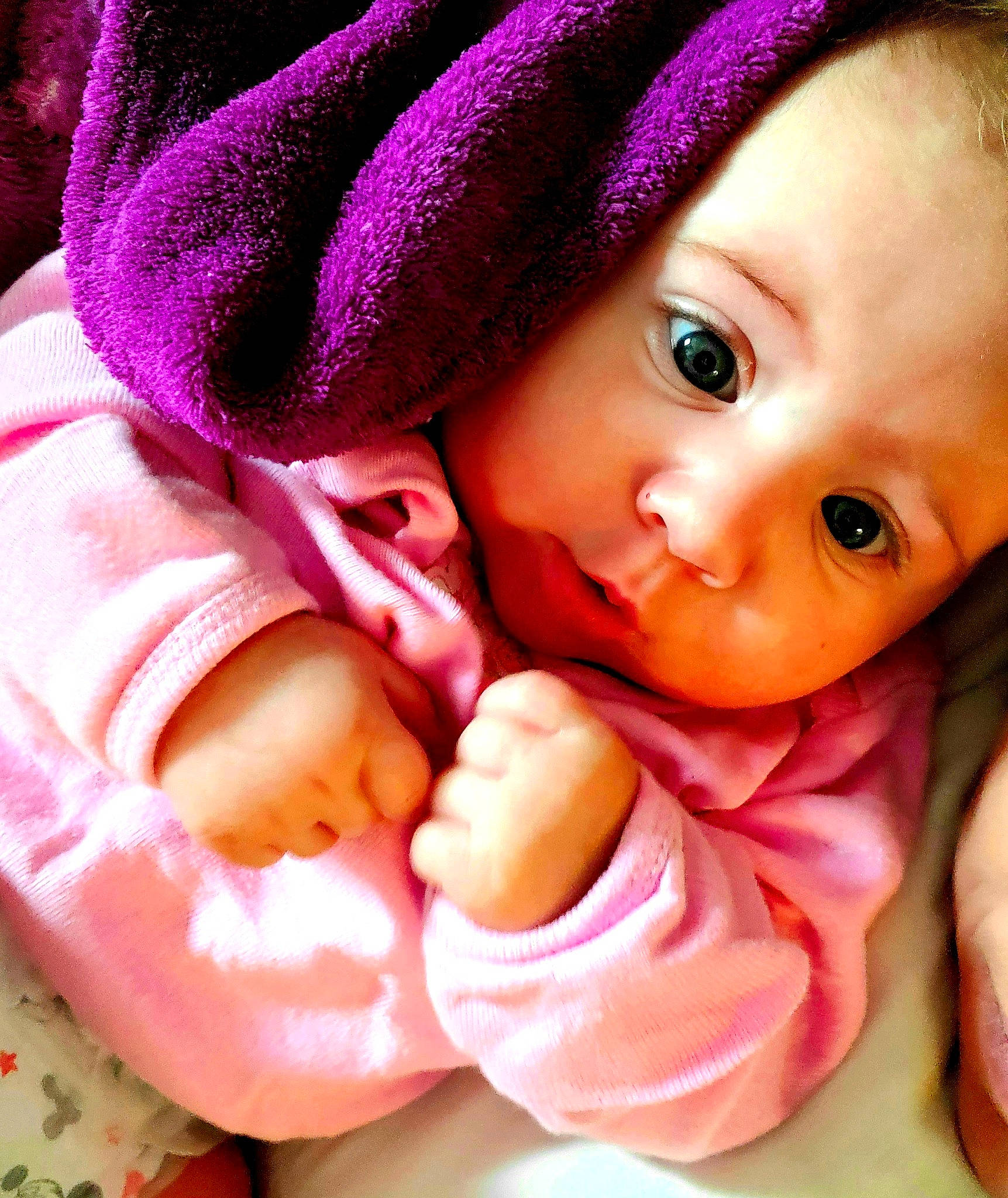 Adilynn is registered to the contest to win money with this photo: baby, cheek, child, close_up, eye, face, finger, hand, head, headgear, lip, mouth, nose, person, pink, skin, smile, thumb, toddler