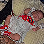 Cylas joined the competition — help win amazing prizes! baby, sleeping, infant, onesie, red_socks, pillow, blanket, tattoo, leg, indoor, cozy, resting, person, footwear, closeup, soft_texture, comfort, child, cute, peaceful