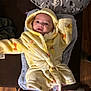 Cylas joined the competition — help win amazing prizes! baby, child, yellow_robe, hood, blanket, pillow, dinosaur_print, smiling, indoor, floor, wood_floor, feet, happy, lying_down, soft_texture, cozy, person, infant, cute, warm_lighting