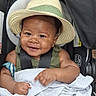 baby, child, infant, smiling, happy, portrait, car_seat, hat, straw_hat, blanket, harness, seated, indoor, close_up, face, arms, hands, clothing, photography, cute