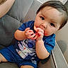 toddler, child, baby, blue_clothing, couch, indoor, face, messy_hands, food_stains, cute, sitting, curious, portrait, young_child, short_hair, skin, person, casual, expression, fun