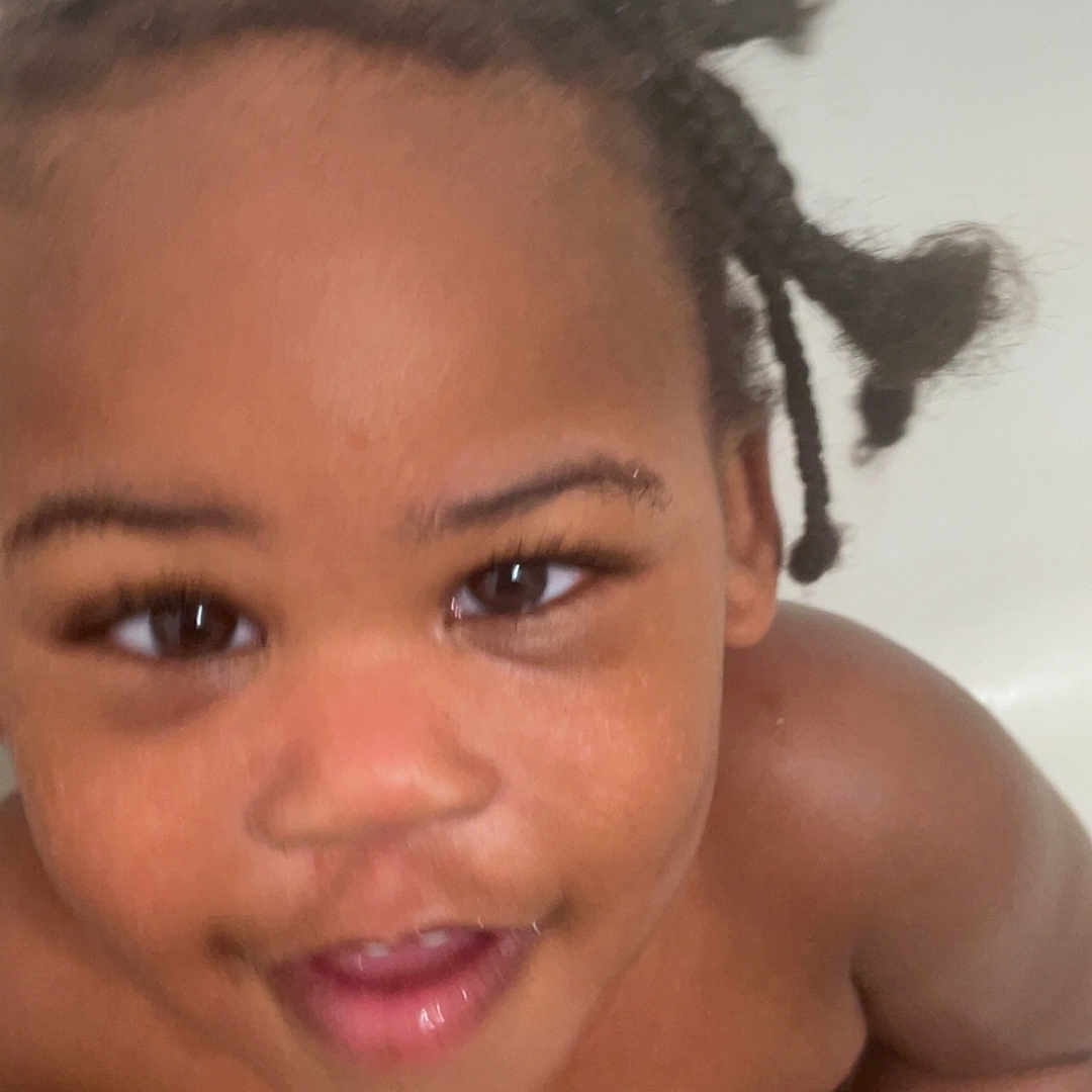 Keylon joined the competition — help win amazing prizes! toddler, child, bathtub, smiling, braided_hair, wet_skin, indoor, bathroom, tile_wall, blue_cloth, person, cute, happy, playing, young_child, looking_up, skin, water_droplets, close_up, portrait
