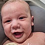 baby, smiling, wet_skin, towel, bath_time, child, closeup, happy, face, infant, skin, head, eyes, mouth, expression, indoors, person, water_droplets, young_child, cheerful