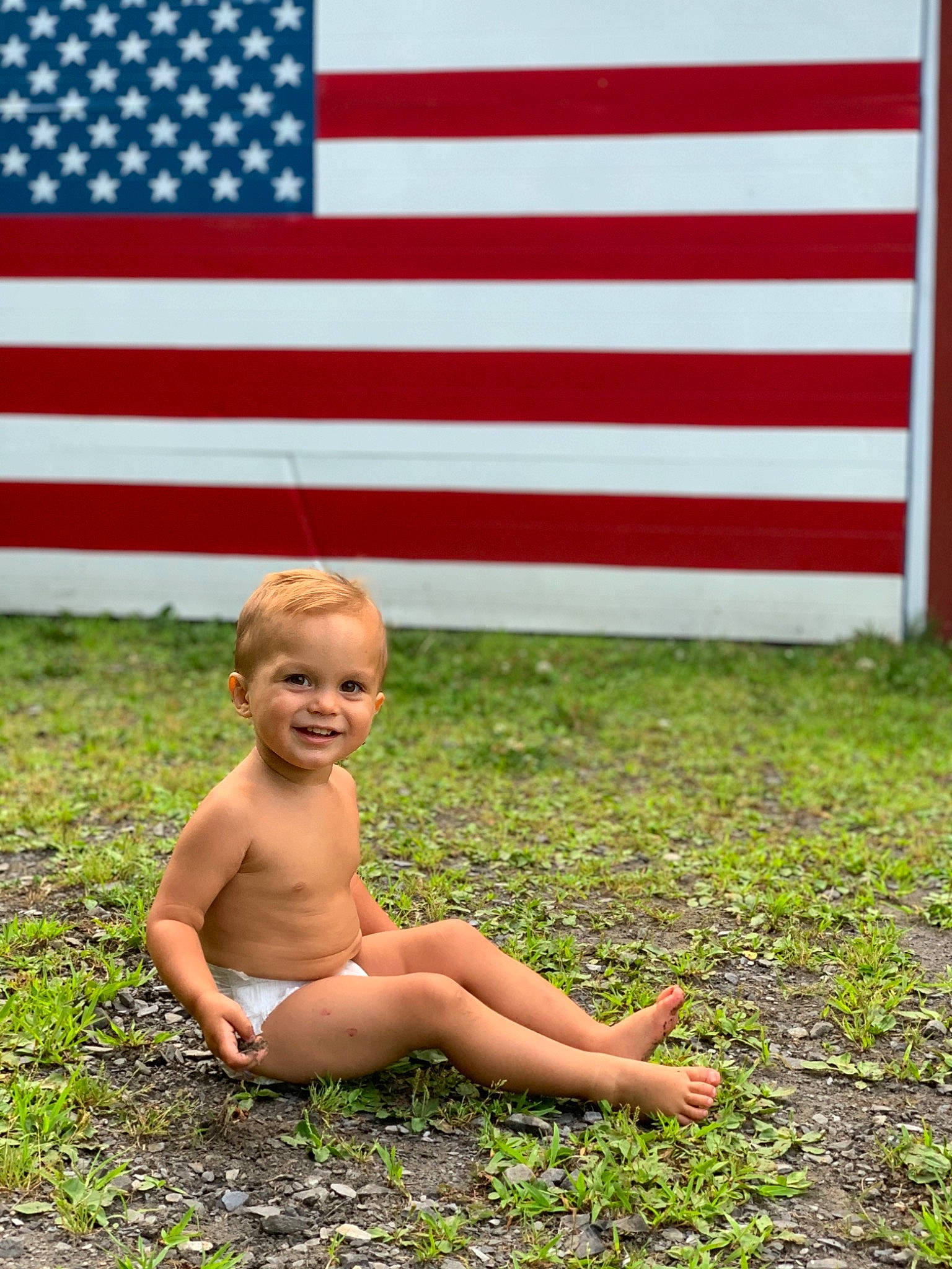 Lochlan joined the competition — help win amazing prizes! child, flag, flag_of_the_united_states, fun, grass, holiday, joy, person, plant, red, sitting, summer, toddler, vacation