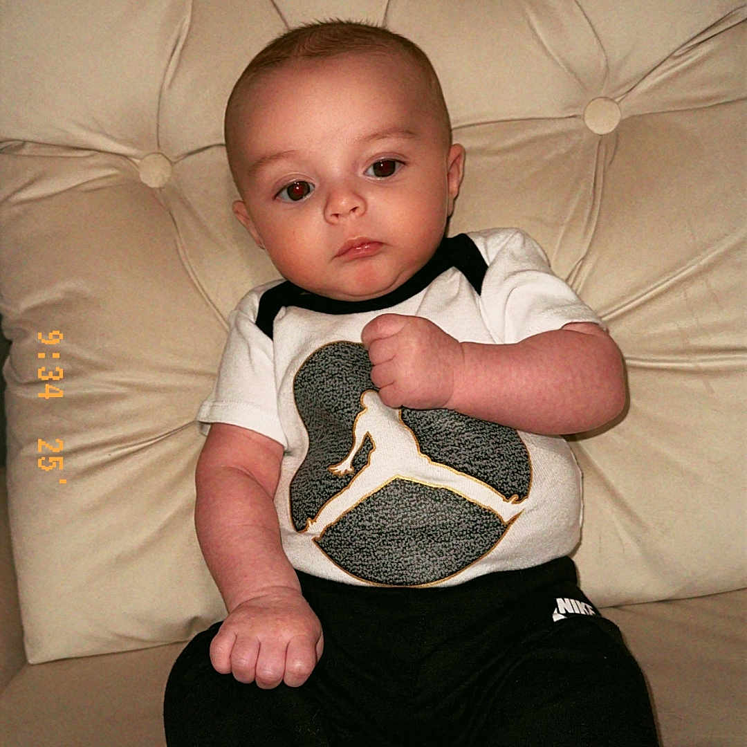 Sebastian Kai joined the competition — help win amazing prizes! baby, buttoned_cushion, casual, child, clothing, couch, expressionless, face, foot, hand, indoor, infant, nike, pants, person, portrait, sitting, sportswear, tshirt, young