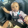 Allandrius is registered to the contest to win money with this photo: toddler, child, car_seat, car_interior, seatbelt, polo_shirt, shorts, pacifier_clip, curly_hair, window, greenery, safety_harness, baby, person, indoor, seat, clothing, skin, portrait, young_child