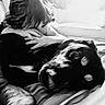 Nia joined the competition — help win amazing prizes! child, dog, black_and_white, couch, hug, resting, indoor, pet, love, affection, cozy, sleepy, portrait, human, animal, friendship, comfort, relaxation, hair, face