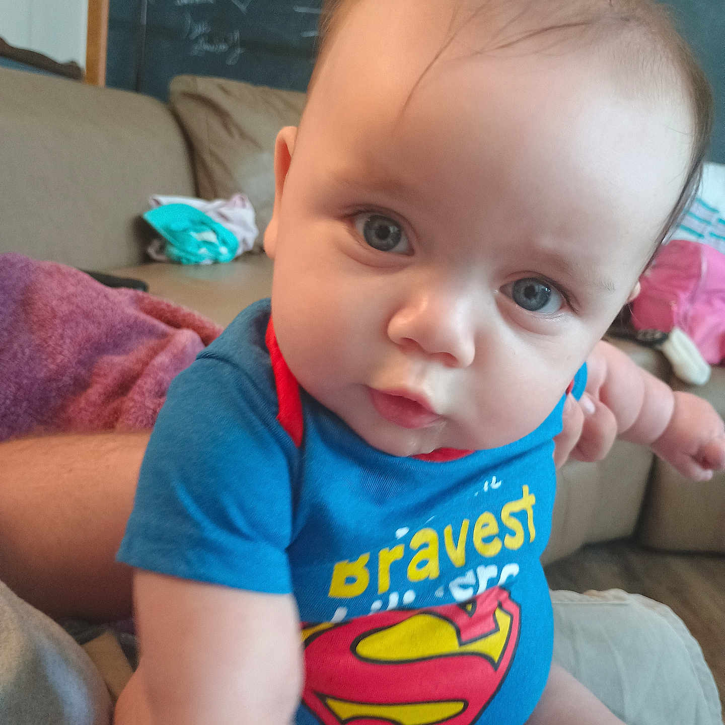 Shyler joined the competition — help win amazing prizes! baby, blackboard, bodypart, clothing, couch, cushion, face, finger, frown, furniture, hand, head, homedecor, linen, person, photography, portrait, sad, sitting, t_shirt