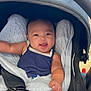 baby, car_seat, blanket, bottle, smile, infant, child, clothing, seatbelt, happy, indoors, person, cute, comfort, sitting, baby_toy, fabric, portrait, nappy, head