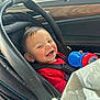 baby, car_seat, smiling, child, car_interior, seatbelt, red_clothing, toy, sippy_cup, happy, infant, window, sunlight, transportation, seat, safety, cheerful, person, young_child, casual
