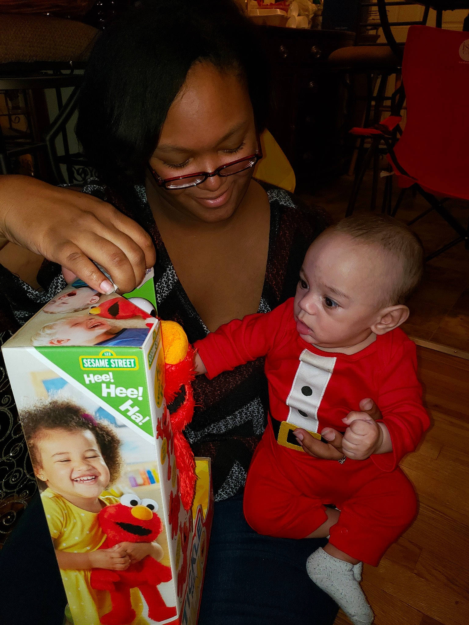 Brady is registered to the contest to win money with this photo: child, christmas, event, fun, glasses, holiday, infant, joy, lap, person, product, red, smile, toddler, vision_care