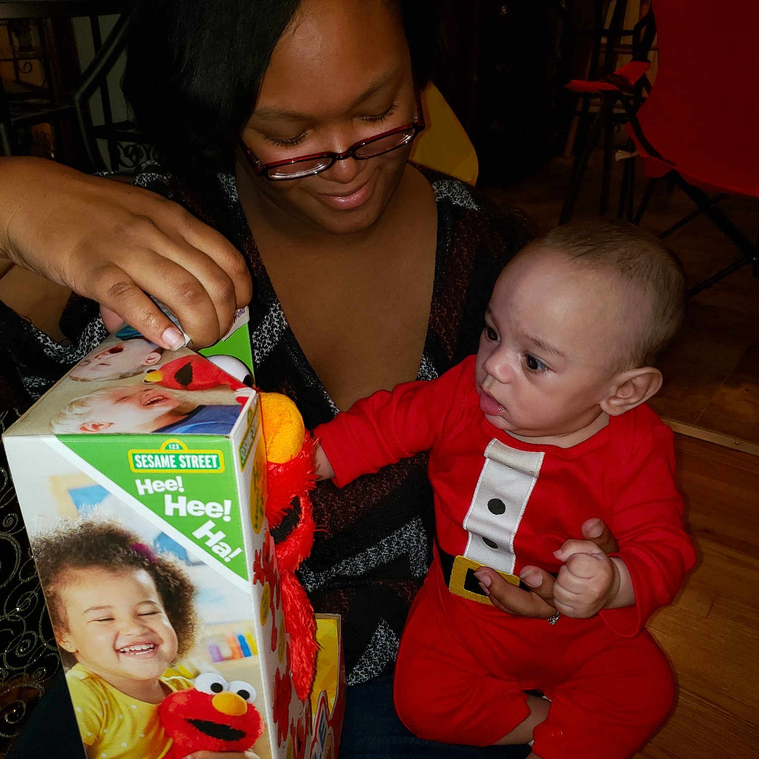 Brady is registered to the contest to win money with this photo: child, christmas, event, fun, glasses, holiday, infant, joy, lap, person, product, red, smile, toddler, vision_care