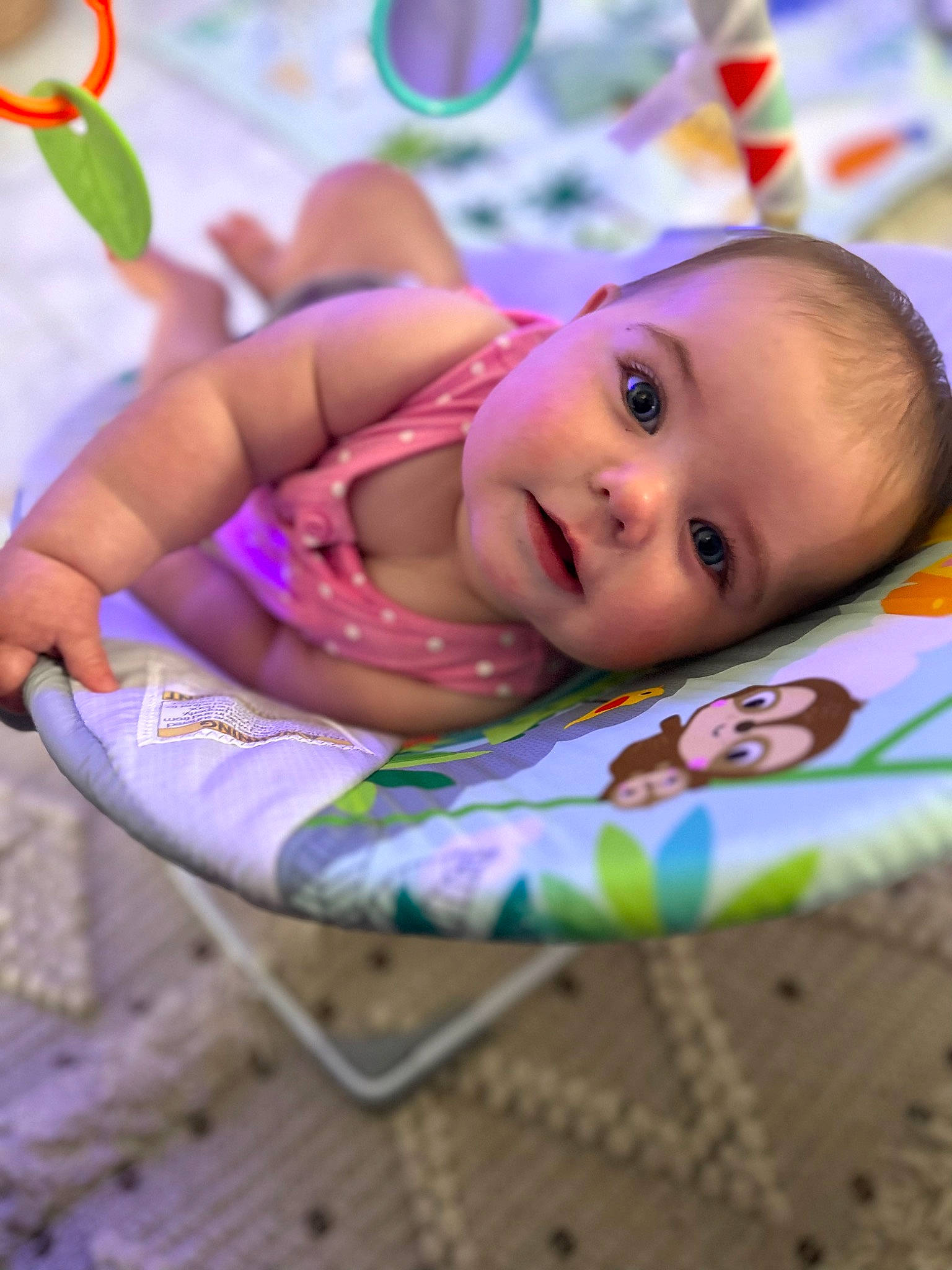 Scarlett joined the competition — help win amazing prizes! baby, baby_products, baby_toddler_clothing, cheek, child, dress, eyelash, fun, grass, happy, iris, lip, pattern, person, pink, purple, sitting, skin, smile, toddler