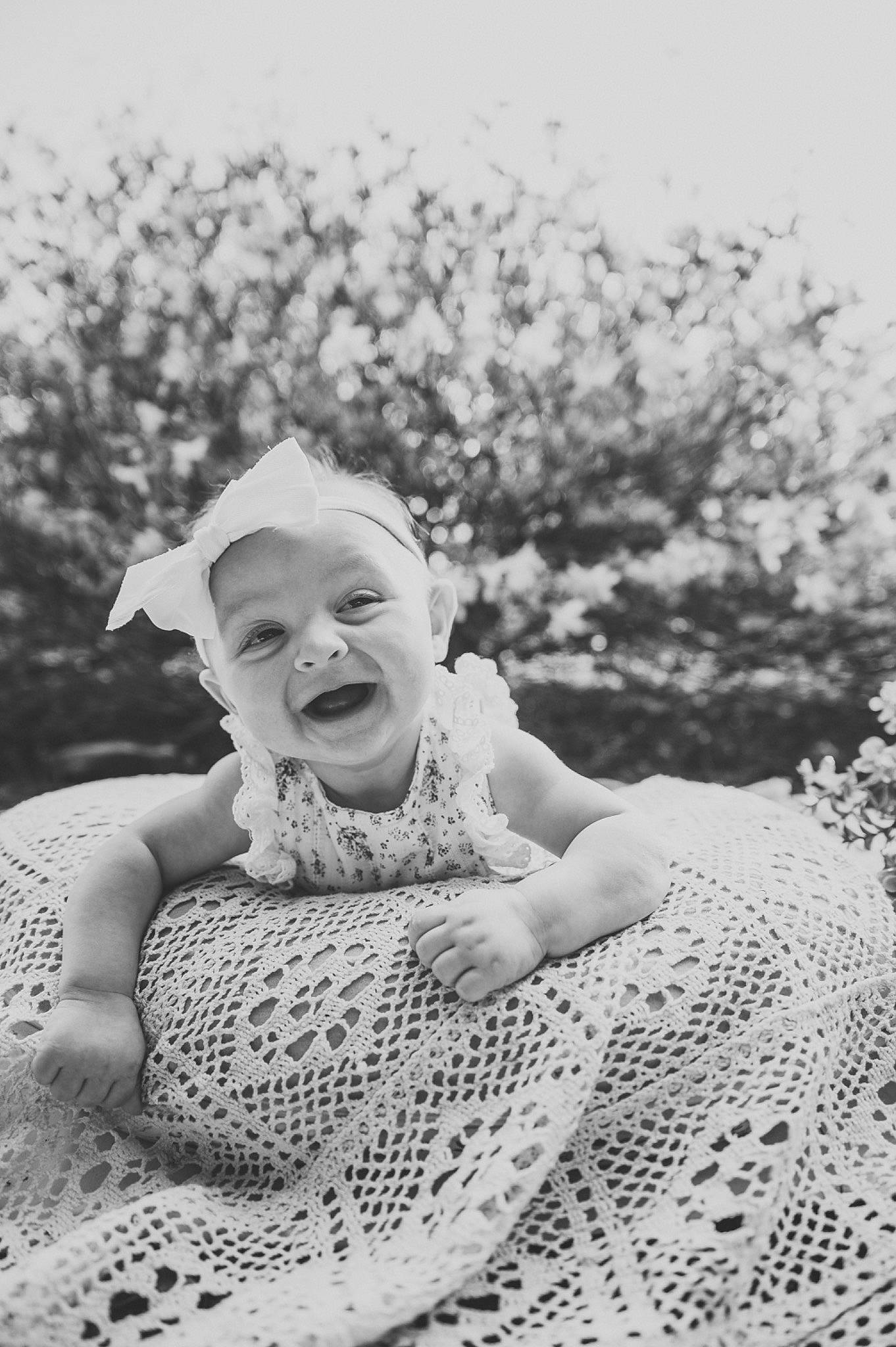 Molly is registered to the contest to win money with this photo: art, baby, child, flash_photography, fun, fur, grass, happy, laugh, linens, monochrome, monochrome_photography, pattern, people_in_nature, person, portrait_photography, sitting, smile, toddler, vintage_clothing