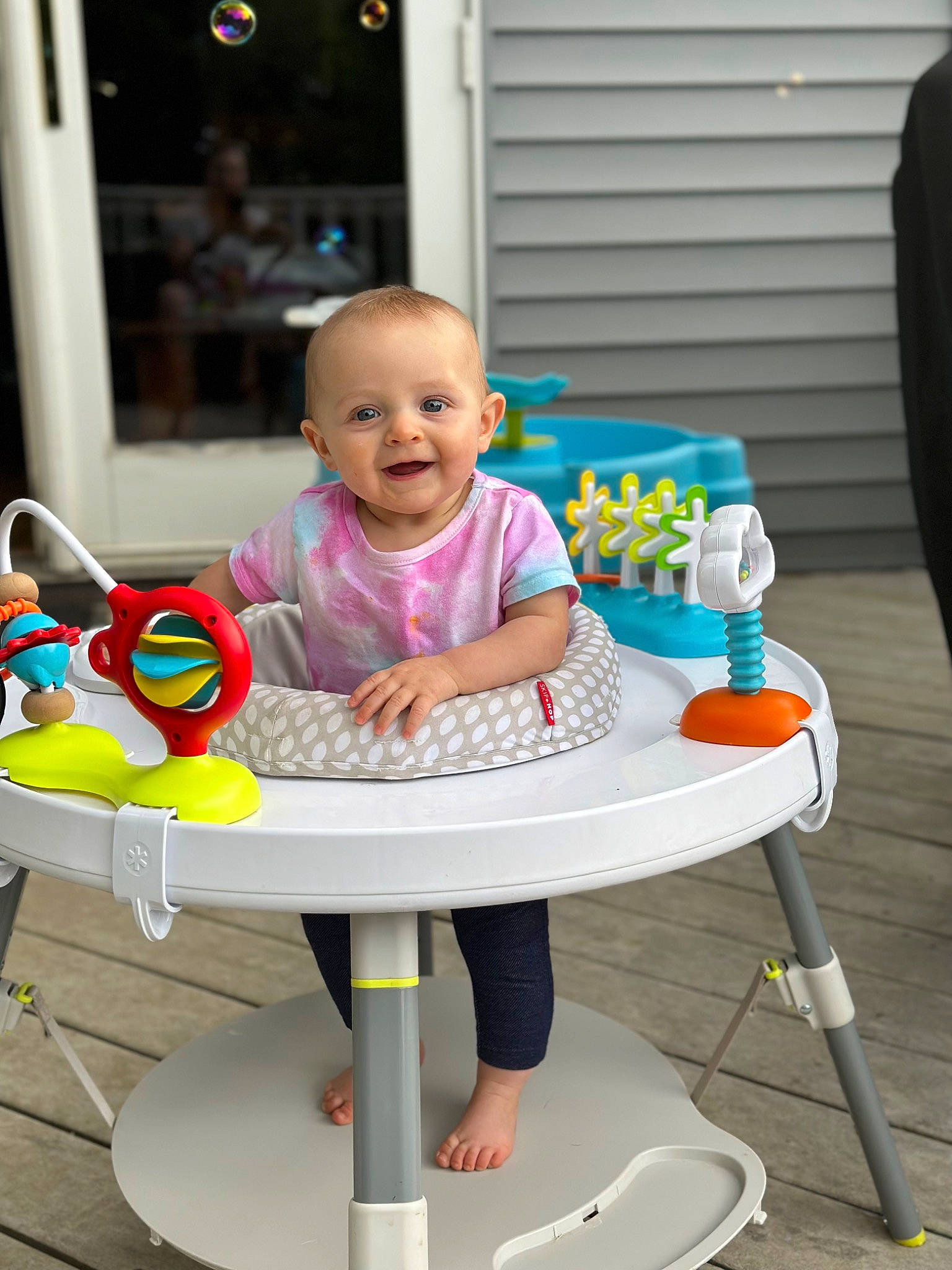 Molly is registered to the contest to win money with this photo: baby, baby_products, baby_toddler_clothing, baby_toys, chair, child, fun, happy, joy, leisure, outdoor_furniture, person, play, recreation, room, shorts, sitting, smile, table, toddler