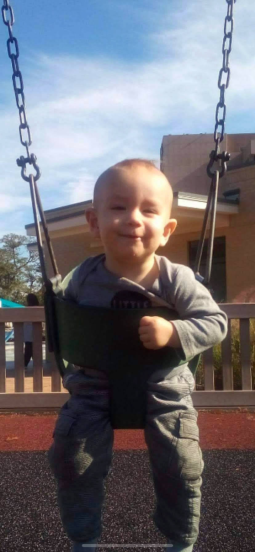 Davian is registered to the contest to win money with this photo: baby, baby_toddler_clothing, cloud, cool, face, finger, fun, gesture, grass, hairstyle, happy, joy, leisure, person, sky, sleeve, smile, standing, swing, thumb