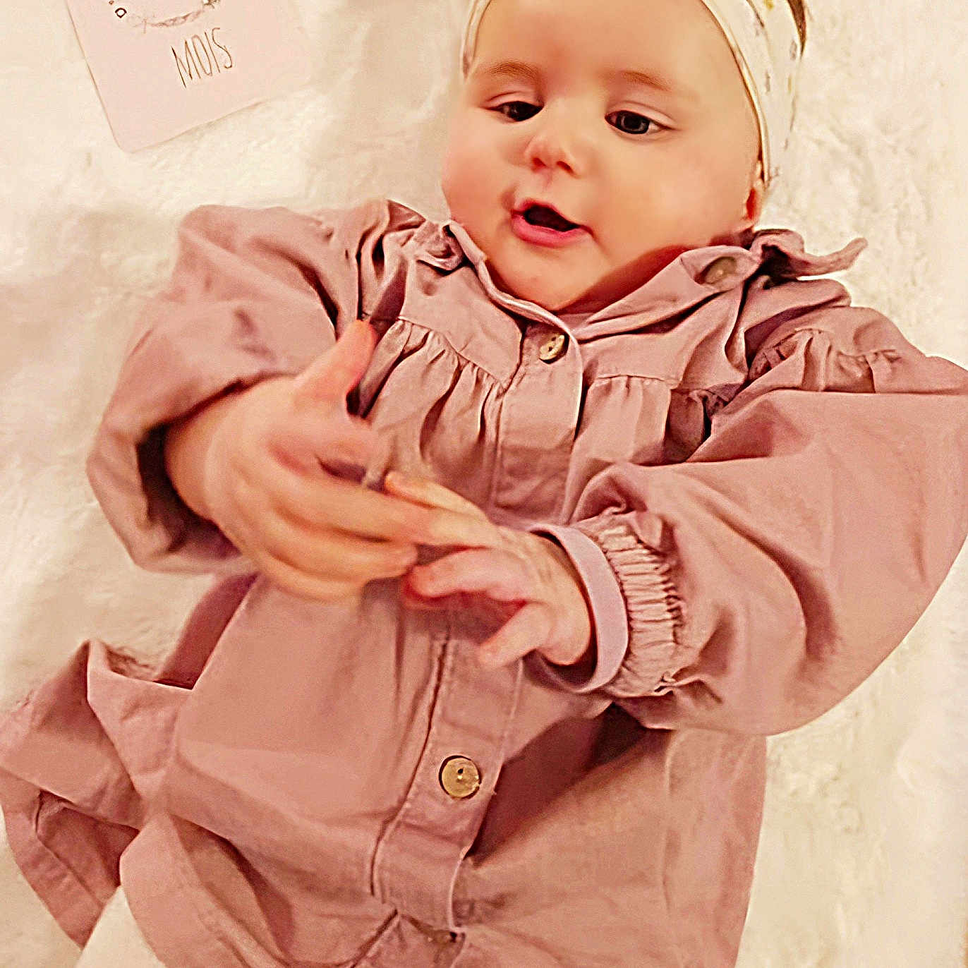 Emy participe au concours pour gagner de l'argent avec cette photo : accessories, baby, bodypart, bonnet, clothing, coat, face, finger, hand, happy, hat, head, headband, jacket, newborn, person, photography, portrait, sleeve, smile