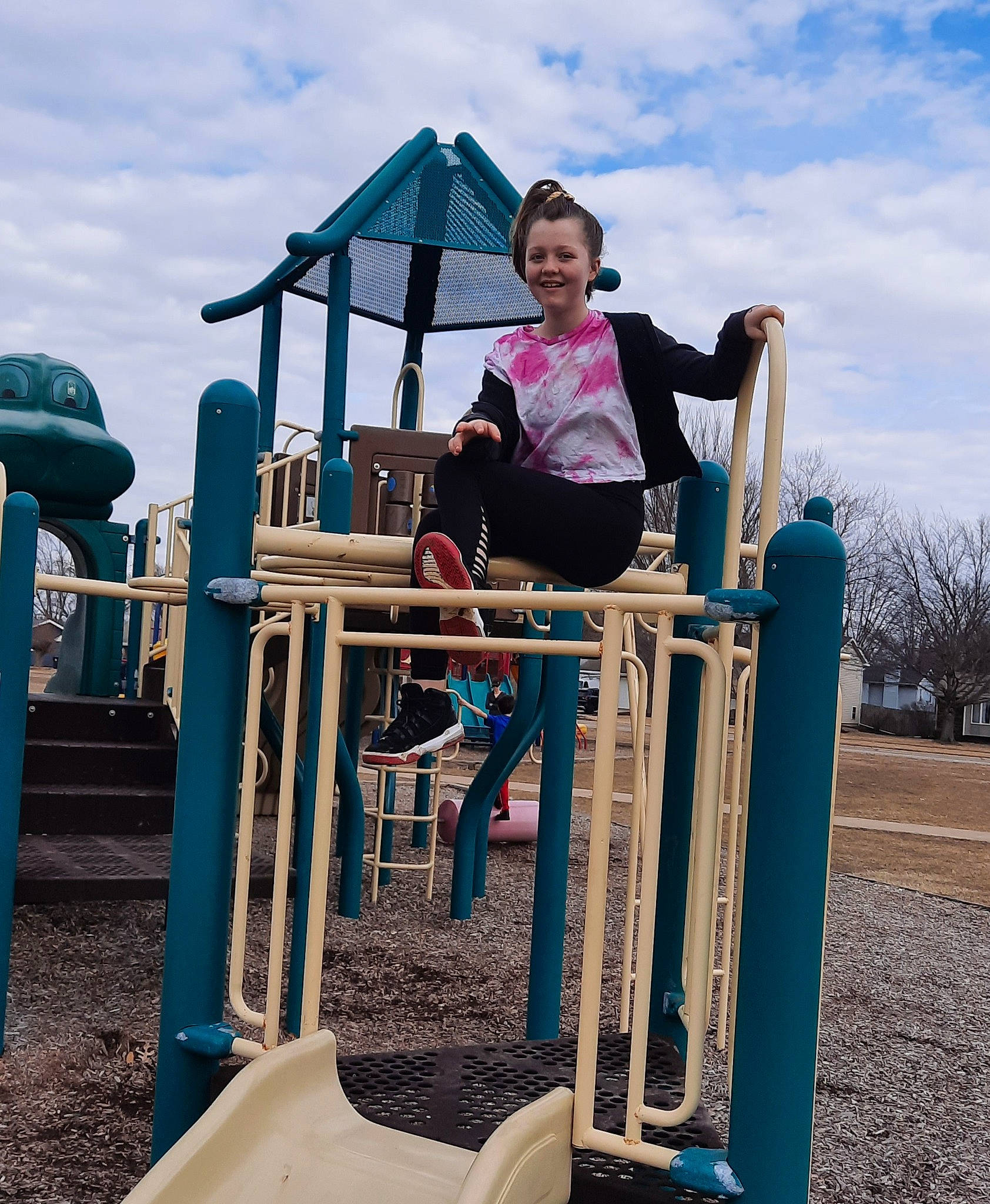 Destiny is registered to the contest to win money with this photo: blue, chute, city, cloud, electric_blue, fun, grass, happy, joy, leisure, outdoor_play_equipment, outdoor_recreation, person, play, playground, playground_slide, recreation, sky, smile, soil
