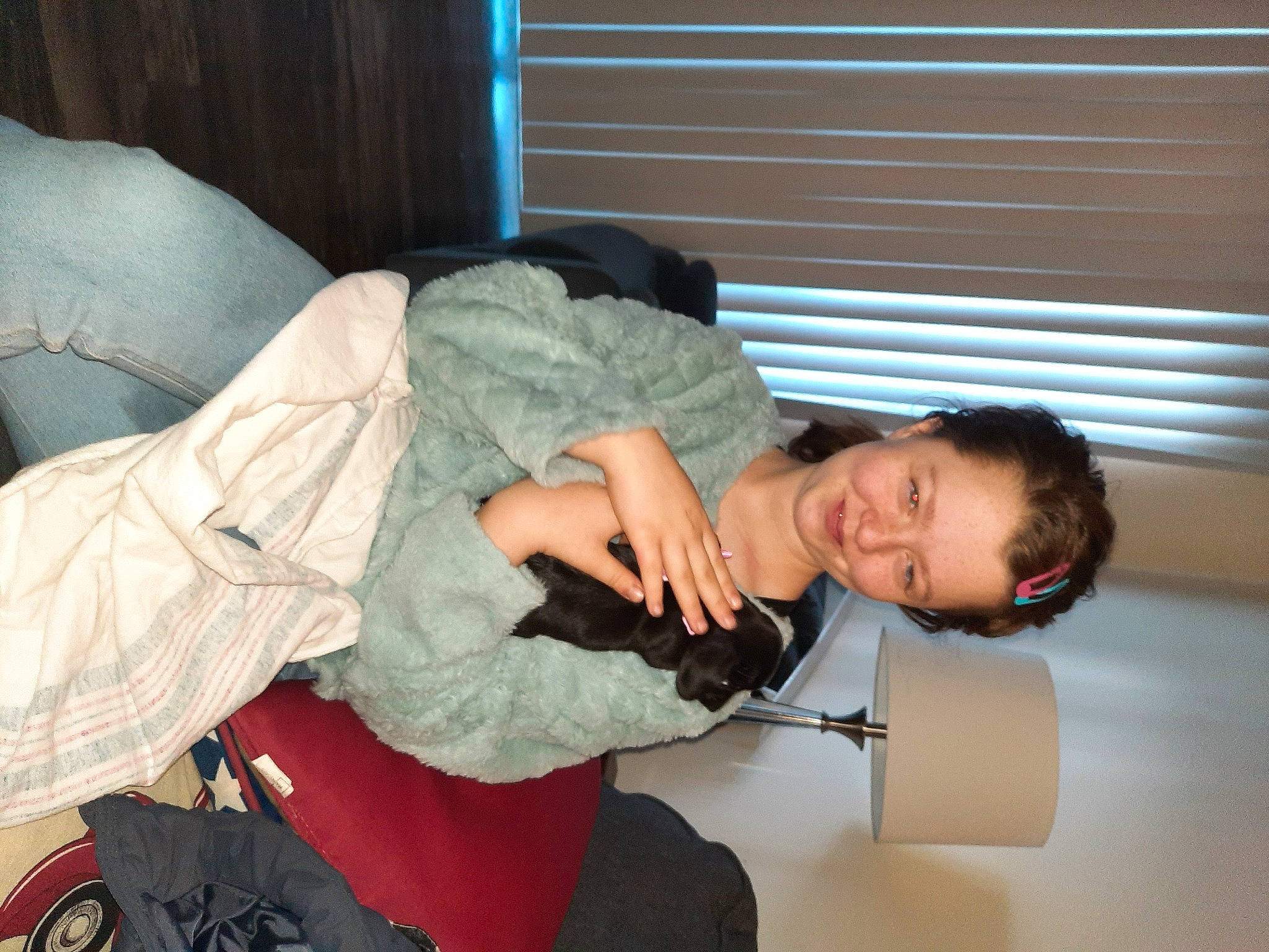 Destiny is registered to the contest to win money with this photo: abdomen, child, comfort, couch, curtain, elbow, fun, human_leg, joy, knee, lap, person, room, shoulder, sitting, thigh, trunk, window, window_blind, window_covering