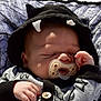 baby, pacifier, sleeping, hood, black_hood, white_horns, hand, blanket, net, infant, clothing, cute, resting, face, peaceful, toddler, child, soft_light, portrait, closeup