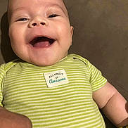 Anthony is registered to the contest to win money with this photo: baby, child, smiling, onesie, green_stripes, patch, happy, face, infant, cute, portrait, lying_down, skin, hand, closeup, indoors, clothing, person, joyful, expression