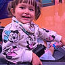 Leilanny is registered to the contest to win money with this photo: toddler, child, smiling, face, hoodie, minnie_mouse, pigtails, stroller, indoor, orange_floor, person, happy, clothing, footwear, casual, cute, young_child, seated, playful, joy