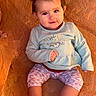 toddler, child, baby, pigtails, pink_clips, blue_top, floral_design, pink_leggings, patterned_leggings, socks, rock_background, orange_rock, sitting, portrait, cute, curious, smiling, outdoor, natural_light, closeup