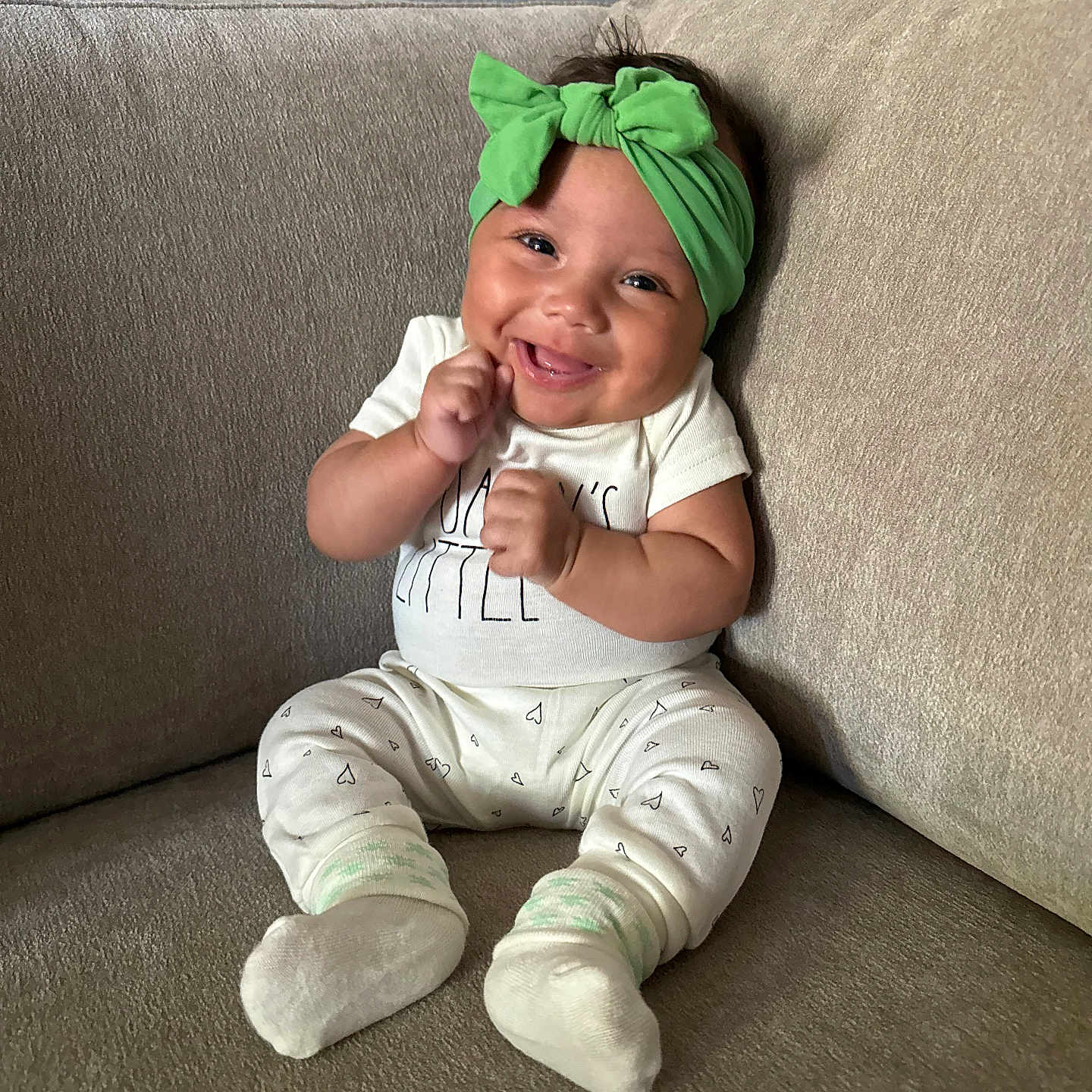 Jalanni joined the competition — help win amazing prizes! baby, baby_clothes, beige, child, couch, cozy, cute, furniture, green_headband, happy, headwear, hearts_pattern, indoors, infant, person, portrait, sitting, smile, sock, white_outfit