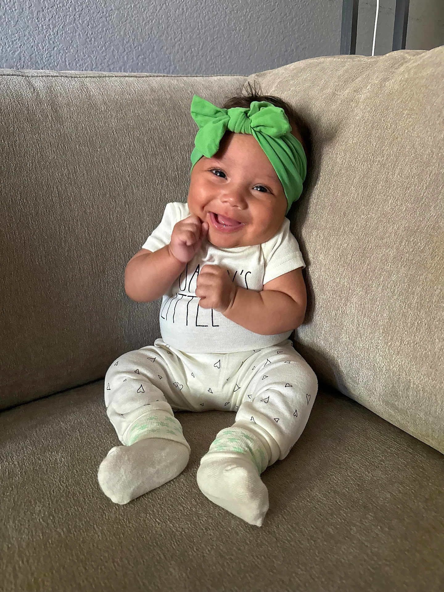 Jalanni joined the competition — help win amazing prizes! baby, baby_clothes, beige, child, couch, cozy, cute, furniture, green_headband, happy, headwear, hearts_pattern, indoors, infant, person, portrait, sitting, smile, sock, white_outfit