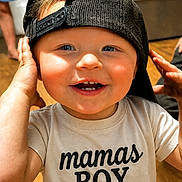 Xander is registered to the contest to win money with this photo: toddler, child, boy, smiling, blue_eyes, cap, backwards_cap, tshirt, mamas_boy, hands, face, indoor, wooden_floor, happy, cute, baby, portrait, casual, playful, closeup